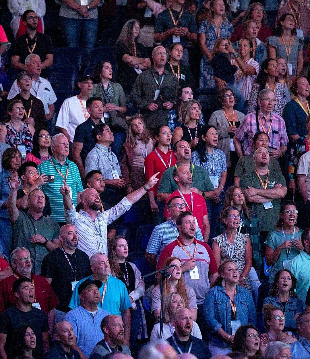 Thousands of believers singing together at Sing! Conference